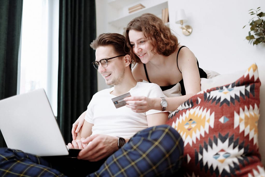 Couple making a purchase together using a credit card on the computer.