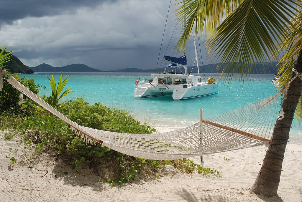catamaran-6574213_1280 Hammock on the beach overlooking a cataraman in the turquoise water.