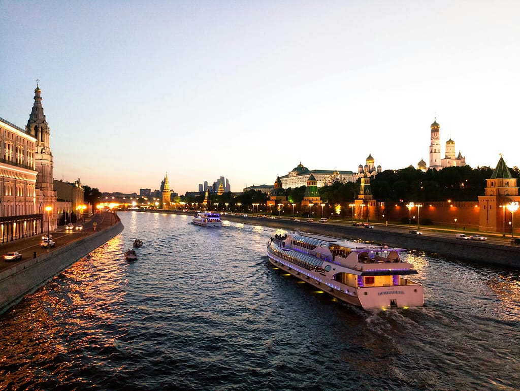 pexels-sergey-sh-1439367-2775742 River cruise ship sailing down the river at dusk.