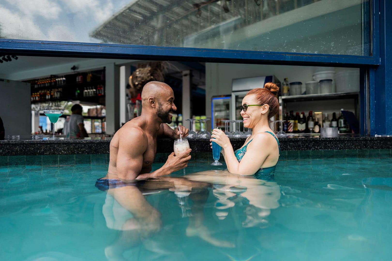Couple drinking at swim-up bar