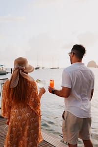 TAC Image (9) couple having drinks by the ocean on their honeymoon