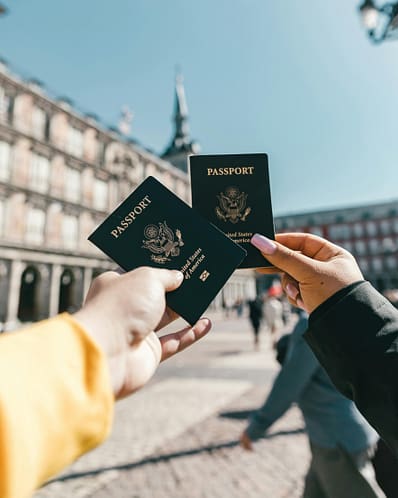 pexels-spencer-davis-4353813 Couple holding passports out for a picture while they are abroad.