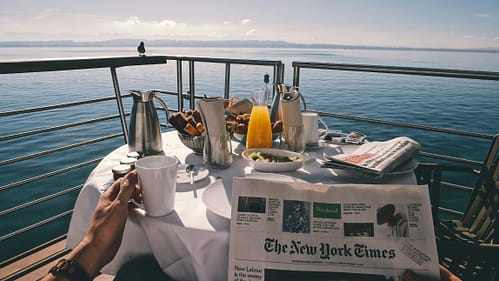 reynier-carl-kqZH-B7IX7o-unsplash (1) Someone enjoying an oceanside breakfast on a ship.