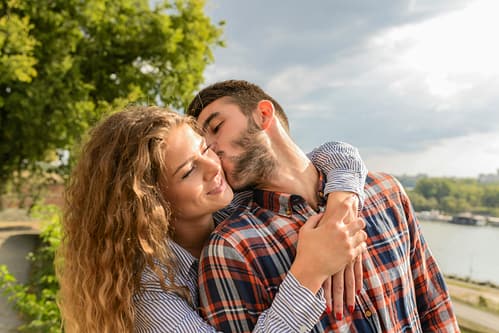 pexels-vera-arsic-304265-984923 Couple embracing each other next to a river.