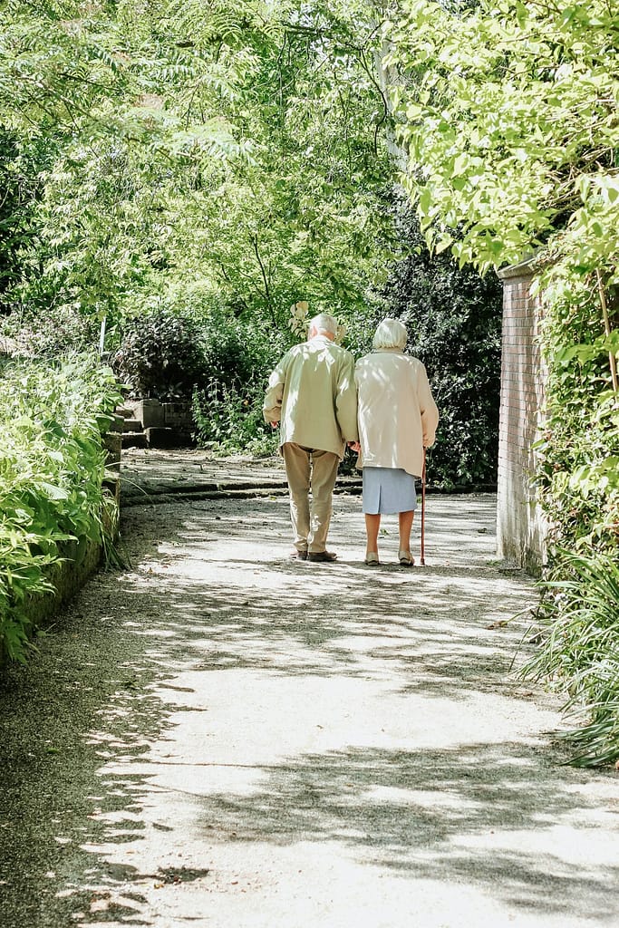 photo-1559234938-b60fff04894d Elderly couple taking a walk through the park. Arboretum Trompenburg, Rotterdam.