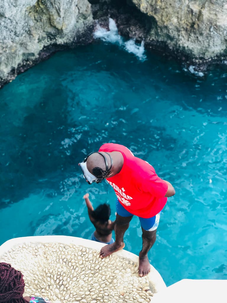 pexels-calandra-648943-1869329 Couple playing in the water and jumping off the cliffs of Negril, Jamaica