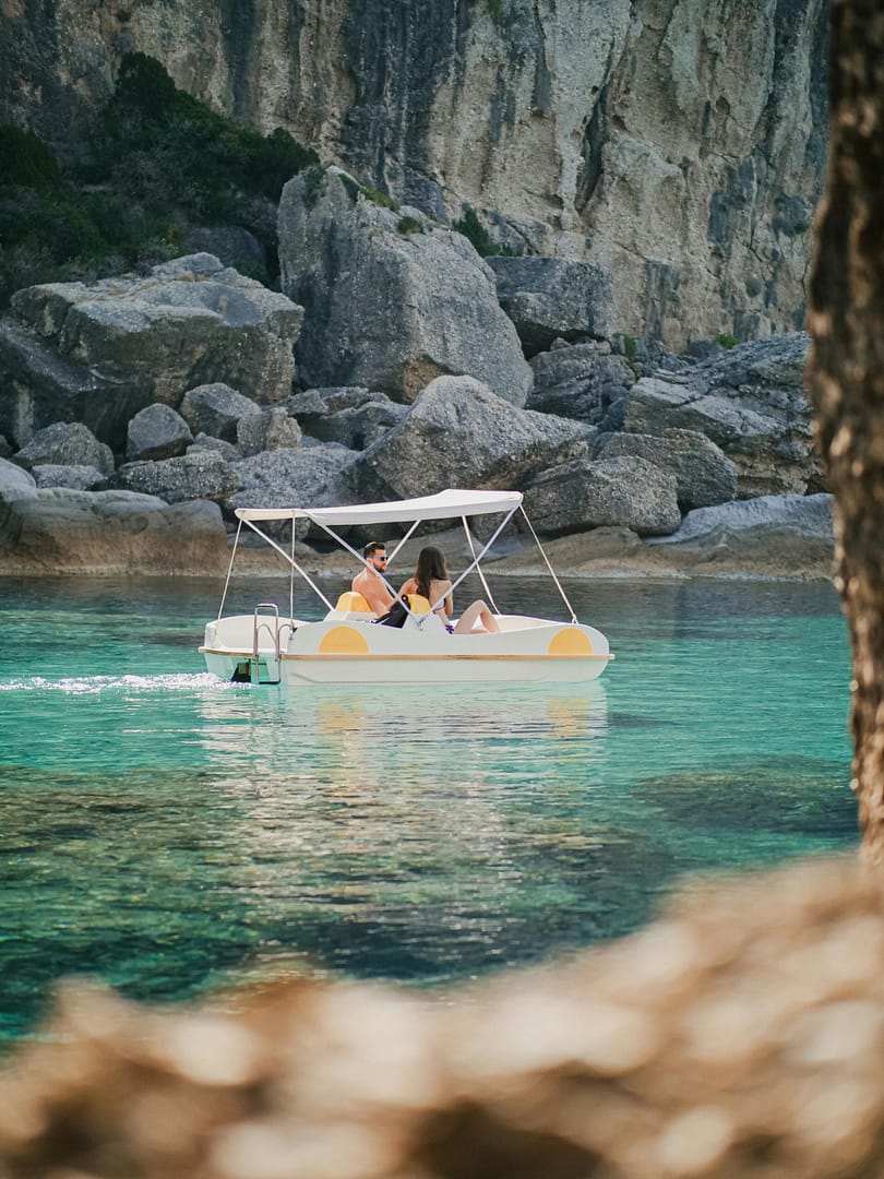 pexels-bohlemedia-4983189 Couple paddling in a paddle boat in Greece.